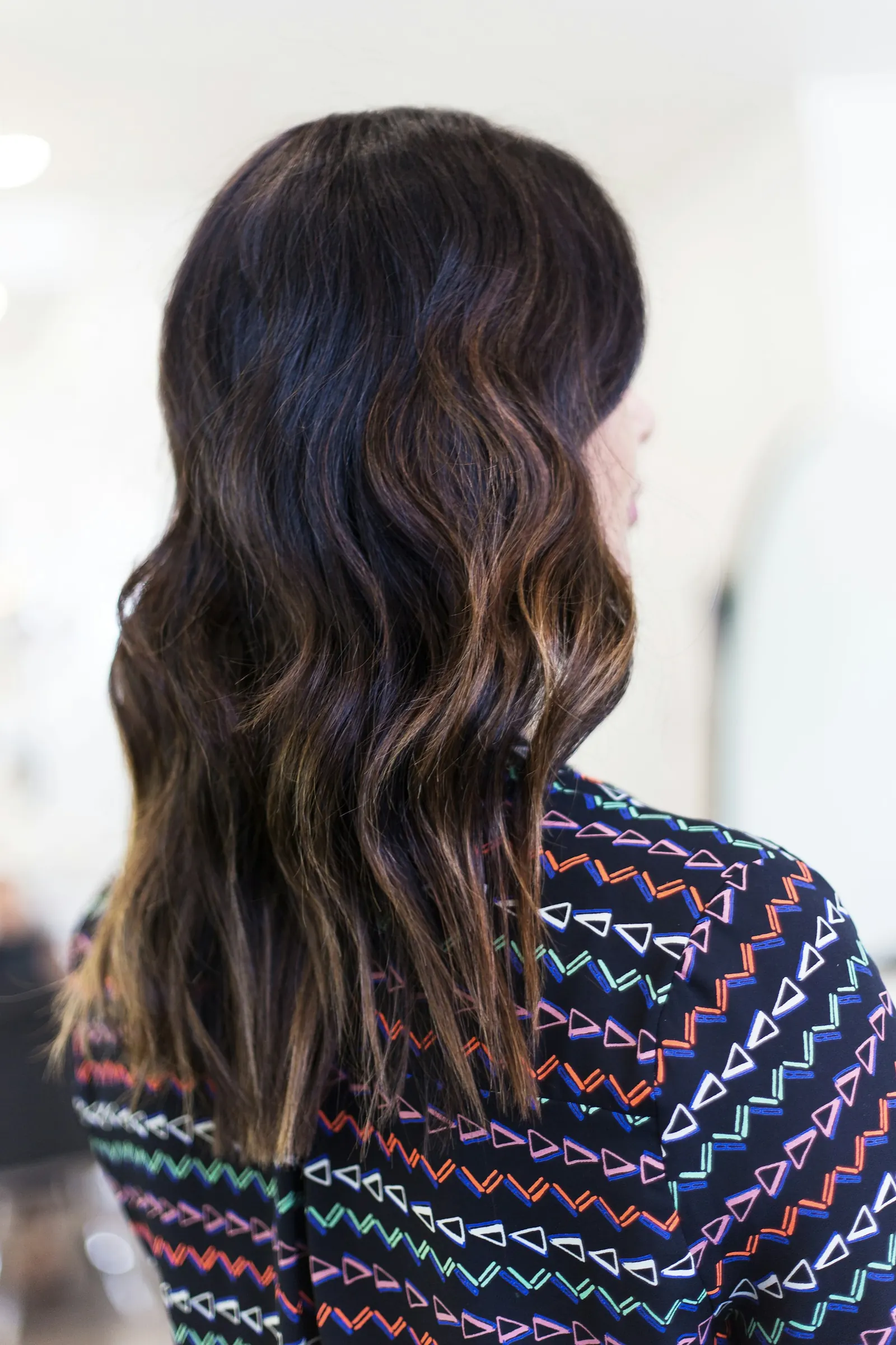 Glossy brunette waves with caramel ends