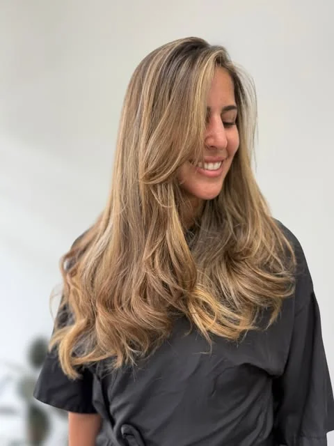 Face-framing blonde balayage, done at Artistic Trendz