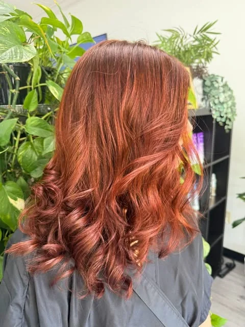 Copper red color with soft curls, done at Artistic Trendz