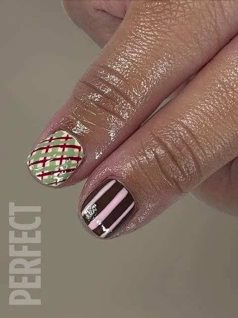 Plaid and striped nail art, done at Artistic Trendz