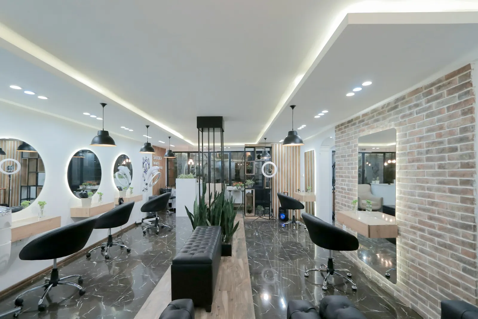 Modern salon with black chairs and round mirrors